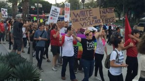 Dozens of demonstrators gathered in front of LAPD headquarters Saturday evening to protest the violence in Charlottesville. (Credit: Carlos Lozano/ Los Angeles Times.)