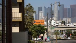 Traffic on the 101 Freeway passes by the recently built Santa Cecilia Apartments in Boyle Heights. (Credit: Brian van der Brug / Los Angeles Times)