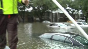 Amid multiple submerged vehicles, a boater navigates the floodwaters near Houston as he helps with rescue efforts on Aug. 29, 2017. (Credit: KTLA)