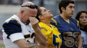 Family members attend a ceremony to retire the number of former Santa Monica High School team captain Juan Castillo, who was shot to death in February. (Credit: Gary Coronado / Los Angeles Times)