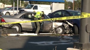 An Orange County Sheriff's Department official investigates the scene of a fatal crash in Stanton on Aug. 15, 2017. (Credit: KTLA)