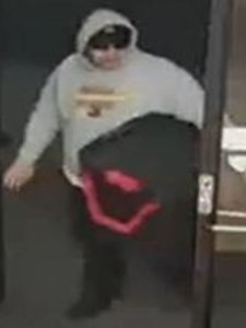 A man suspected in several robberies at Verizon stores in Orange County is seen in an image provided by the Santa Ana Police Department. 