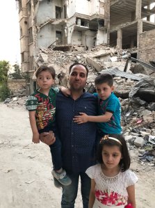 Mohammed Kheir Daqneesh is surrounded by his three children in Aleppo. (Credit: CNN)