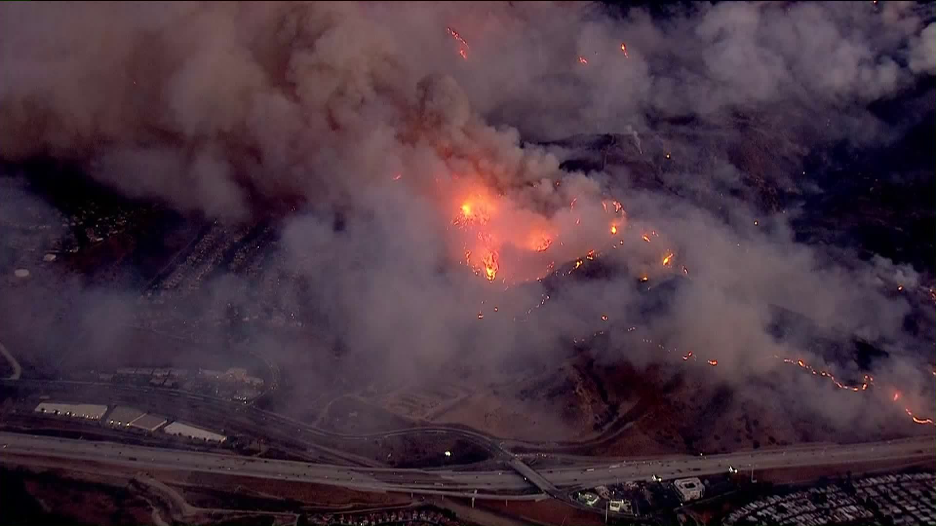 The Canyon Fire burns close to homes at the border with Corona and Anaheim on Sept. 25, 2017. (Credit: KTLA)