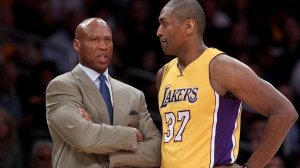Former Lakers coach Byron Scott speaks with player Metta World Peace during a game against the Orlando Magic in March 2016 at Staples Center. (Luis Sinco/Los Angeles Times)