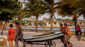 Cubans carry a boat out of the sea on Sept. 8, 2017, ahead of the arrival of Hurricane Irma in the town of Caibarien. (Credit: Adalberto Roque/AFP/Getty Images)