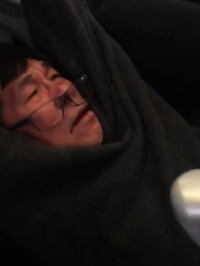 Several passengers on United flight 3411 from Chicago O'Hare International Airport to Louisville, Kentucky, captured video as a man was dragged off the plane by authorities after he apparently refused to leave from an overbooked flight. (Credit: JayceDavid/Twitter)