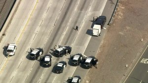 A driver surrenders to CHP after a pursuit that lasted about two hours ended on the 210 Freeway in the East Pasadena area on Sept. 18, 2017. (Credit: KTLA)