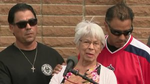 Lucy Hernandez, center, is flanked by her two sons, Steve (left) and Adrian (right), during a news conference about her slain husband on Sept. 13, 2017. (Credit: KTLA)