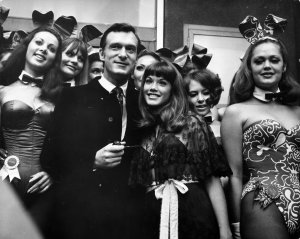 Hugh Hefner is seen with longtime partner and Playboy model Barbi Benton, right, among "bunny girls" at his London Playboy Club in 1962. (Credit: Michael Webb / Getty Images)