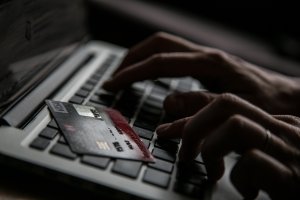 In this photo illustration a woman uses a credit card to buy something online (Credit: Matt Cardy/Getty Images)