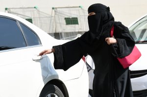 A Saudi woman gets into a taxi at a mall in Riyadh as a grassroots campaign planned to call for an end to the driving ban for women in Saudi Arabia on Oct. 26, 2014. (Credit: FAYEZ NURELDINE/AFP/Getty Images)