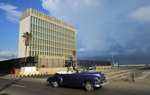 An old American car passes by the U.S. Embassy in Havana on Dec. 17, 2015. (Credit: Yamil Lage / AFP / Getty Images)