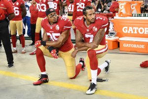 Colin Kaepernick and Eric Reid of the San Francisco 49ers kneel in protest during the national anthem prior to playing the Los Angeles Rams in their NFL game at Levi's Stadium on Sept. 12, 2016. (Credit: Thearon W. Henderson / Getty Images)