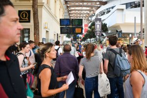 Passengers look at information monitors as they wait for their trains at The Saint-Charles Station in Marseille on Aug. 20, 2017. (Credit: Bertrand Langlois / AFP / Getty Images)