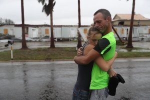 Two people hug after riding out Hurricane Harvey in an apartment on Aug. 26, 2017, in Rockport, Texas. (Credit: Joe Raedle/Getty Images)