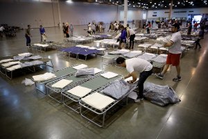 Volunteers set up additional cots for Hurricane Harvey evacuees at the NRG Center August 31, 2017 in Houston, Texas. (Credit: Win McNamee/Getty Images)