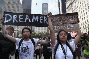 Jovan Rodrigo, 27, and Gloria Mendoza, 26, take part in a protest near Trump Tower on Sept. 5, 2017, in New York City. (Credit: John Moore / Getty Images)