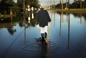Paul Morris checks on neighbors homes in a flooded district of Orange as Texas slowly moves toward recovery from the devastation of Hurricane Harvey on Sept. 7, 2017, in Orange, Texas. (Credit: Spencer Platt / Getty Images)