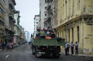 A truck with divers drives along a street of Havana, on Sept. 9, 2017. (Credit: Yamil Lage/AFP/Getty Images)