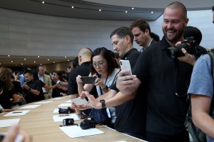 An attendee looks at a new iPhone X during an Apple special event at the Steve Jobs Theatre on the Apple campus on Sept. 12, 2017, in Cupertino. (Credit: Justin Sullivan/Getty Images)