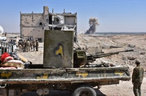 Syrian pro-government forces advance on the northern outskirts of Deir Ezzor on Sept. 14, 2017, during their ongoing battle against the Islamic State group. (Credit: George Ourfalian / AFP / Getty Images)