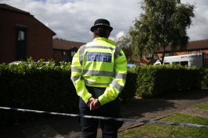 Police stand guard during a search by a police forensics team in Stanwell, Surrey, near London on Sept. 17, 2017. (Credit: Daniel Leal-Olivas / AFP / Getty Images)