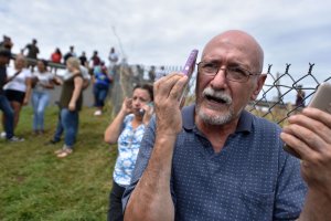 A man manages to speak by cellphone to his family in the United States from Vega Alta, 45 km north of San Juan, Puerto Rico, on Sept. 23, 2017. (Credit: Hector Retamal / AFP / Getty Images)