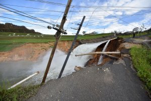 Overflow from the damaged Guajataka River Dam is seen in San Sebastian, in the west of Puerto Rico, on Sept. 23, 2017, following passage of Hurricane Maria. (Credit: Hector Retamal / AFP / Getty Images)