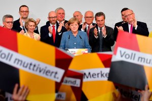 German Chancellor and Christian Democrats party leader Angela Merkel speaks on stage surrounded by her team during an election night event at the party headquarters in Berlin on Sept. 24, 2017. (Credit: TOBIAS SCHWARZ / AFP / Getty Images)