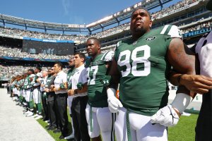 Mike Pennel of the New York Jets stands in unison with his teammates during the National Anthem prior to an NFL game against the Miami Dolphins at MetLife Stadium on Sept. 24, 2017. (Credit: Al Bello/Getty Images)