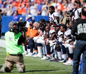 Denver Broncos players kneel during the American National Anthem before an NFL game against the Buffalo Bills on Sept. 24, 2017, at New Era Field. (Credit: Brett Carlsen / Getty Images)