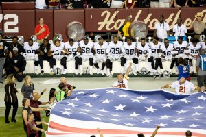 Oakland Raiders players sit during the national anthem before they take on the Washington Redskins at FedExField on Sept. 24, 2017. (Credit: Tasos Katopodis / Getty Images)