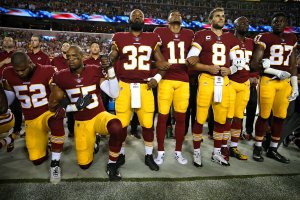 Washington Redskins players kneel and stand during the national anthem before the game against the Oakland Raiders in Landover, Md. on Sept. 24, 2017. (Credit: Patrick Smith/Getty Images)