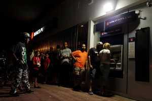 People make line at night at an ATM to withdraw money in San Juan, Puerto Rico, on Sept. 25, 2017. (Credit: Ricardo Arduengo / AFP / Getty Images)
