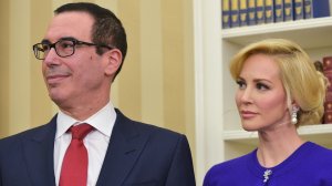Steven Mnuchin and then-financee Louise Linton watch as President Trump speaks during Mnuchin's swearing-in ceremony on Feb. 13, 2017. (Credit: Mandel Ngan/AFP/Getty Images)