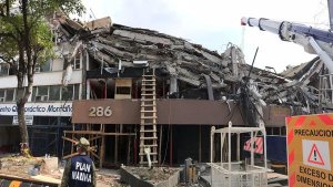 It has been days since the last person was extracted from the building alive, and the stench of death pervades the scene. Twenty bodies have been found. Crews think 10 to 20 remain. (Credit: Rong-Gong Lin II / Los Angeles Times)