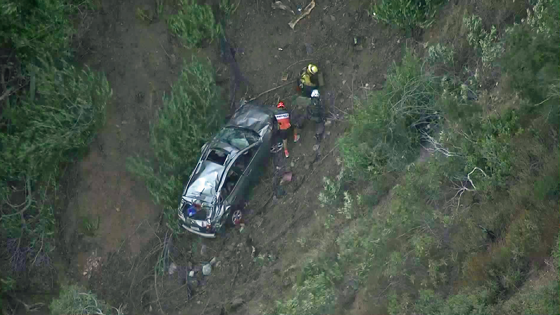Rescuers respond to a car over the side of Glendora Mountain Road on Sept. 28, 2017. (Credit: KTLA)