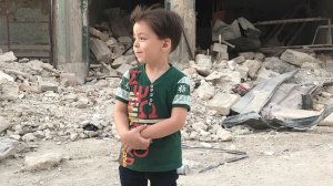 Omran Daqneesh is seen in Aleppo a year after his home partly collapsed in a strike. (Credit: CNN)