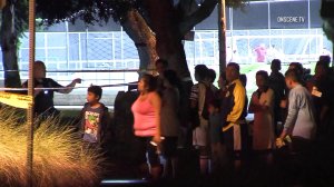 Police talk to possible witnesses at a Santa Ana park where a homicide investigation was underway on Sept. 25, 2017. (Credit: OnScene.TV)