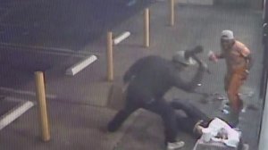 A man in seen striking another man with an ax in store surveillance footage released by the Los Angeles County Sheriff's Department on Sept. 5, 2017.