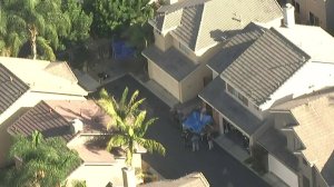 A blurred image shows authorities investigating a fatal shooting in Aliso Viejo on Oct. 12, 2017. (Credit: KTLA)