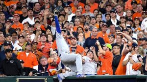 Dodgers first baseman Cody Bellinger goes into the stands to catch a foul ball in the ninth inning in Game 5 of the World Series. (Credit: Wally Skalij/Los Angeles Times)