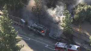 A bus and a car were on fire in Sylmar on Oct. 24, 2017, when record-breaking heat and high winds were in the forecast. (Credit: KTLA)