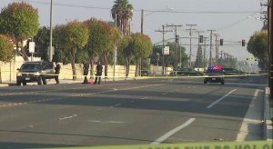 Police inspect a truck that was driven by a man who was shot by officers in Westminster on Oct. 14, 2017. (Credit: KTLA)