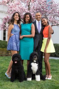 President Barack Obama, First Lady Michelle Obama, and daughters Malia (left) and Sasha (right) pose for a family portrait with their pets Bo and Sunny in the Rose Garden of the White House on Easter Sunday, April 5, 2015 (Credit: Pete Souza/The White House via Getty Images)