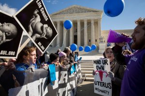 Pro-choice advocates (right) and anti-abortion advocates (left) rally outside of the Supreme Court, March 2, 2016 in Washington, DC. (Credit: Drew Angerer/Getty Images)