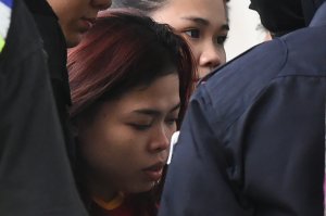 Indonesian national Siti Aisyah, 25, is escorted by police for a court appearance in Sepang on March 1, 2017. (Credit: Mohd Rasfan/AFP/Getty Images)