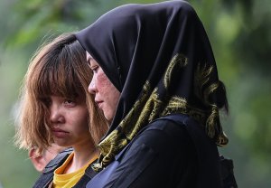 Vietnamese national Doan Thi Huong, 28, who has been charged with the murder of Kim Jong Nam, is escorted by police after a court appearance in Sepang on March 1, 2017. (Credit: Mohd Rasfan/AFP/Getty Images)