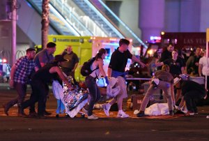 An injured person is tended to in the intersection of Tropicana Ave. and Las Vegas Boulevard after a mass shooting at a country music festival nearby on October 2, 2017 in Las Vegas, Nevada. (Credit: Ethan Miller/Getty Images)